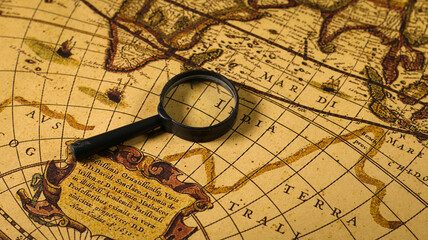 Close up of an old vintage map with magnifying lens