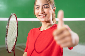 Close up of beautiful girl badminton player with thumbs up