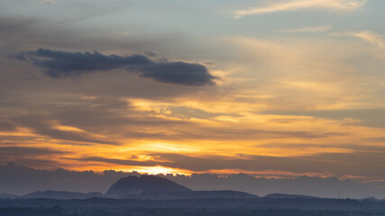 Formation of clouds in the horizon during the golden hour of sunset 
