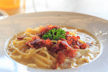 Italian cuisine, Spaghetti Cabana or Spaghetti White Sauce on white dish at restaurant