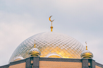 Golden domes of the mosque covered with snow