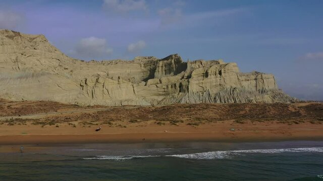 Aerial Over Arabian Sea And Beach With Rugged Mountains Of Hingol National Park In Background. Dolly Forward 