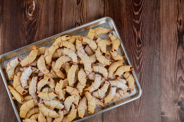 Baked crescent cookies with jam on oven tray.. © Olesya