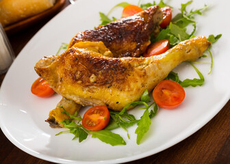Roasted chicken thighs with arugula and tomatoes. Healthy dinner