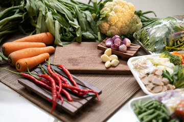 Fresh vegetables on a wooden board and partially wrapped