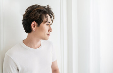 Fototapeta na wymiar Attractive young handsome smiling face positive asian, korean happy casual man, stay home minimal lifestyle. Closeup portrait of asia middle age 20s man wearing white shirt in studio. Young model boy