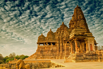 Beautiful image of Kandariya Mahadeva temple, Khajuraho, Madhyapradesh, India with blue sky and fluffy clouds, It is worldwide famous ancient temples in India, UNESCO world heritage site.