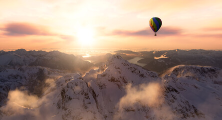 Dramatic Mountain Landscape covered in clouds and Hot Air Balloon Flying. 3d Rendering Adventure Dream Concept Artwork. Aerial Image from British Columbia, Canada. Sunset or Sunrise Sky