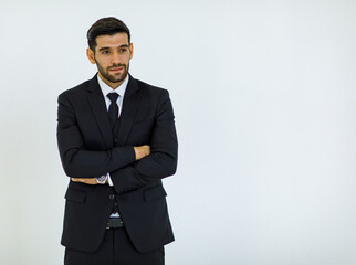Portrait studio cut out shot of Caucasian success handsome bearded male businessman in formal black suit and necktie standing smiling look at camera holding hands in pants pockets on white background