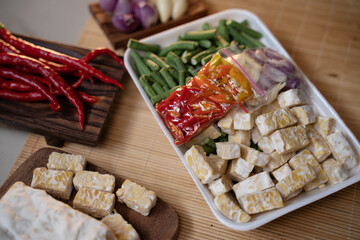 Tempeh and stir-fried spices wrapped in polyethylene polymer packaging foam