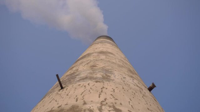 Smoke is coming out of the furnace which is mixed with the air.