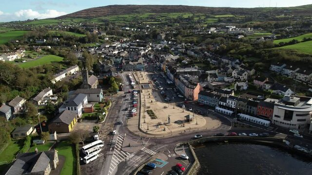 Downtown Bantry, Ireland. Aerial view of buildings, street traffic and green landscape on sunny day - establishing drone shot