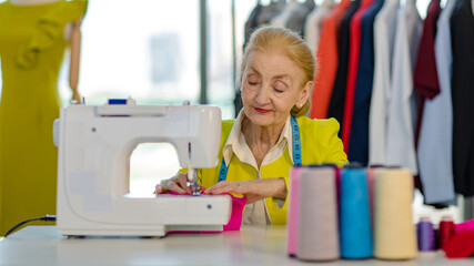 Caucasian old senior professional wrinkled face female designer tailor dressmaker with measure tape...