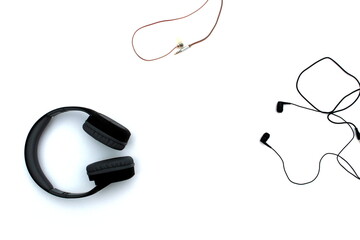 Large and small headphones lie on a white isolated background.