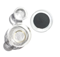 Closeup chemical ingredient on white laboratory table. Zinc Powder in Chemical Watch Glass place next to beaker with alcohol and Erlenmeyer flask. Top View