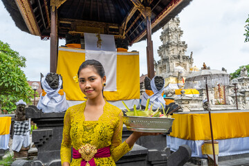 Balinese girl worshipping at a temple
