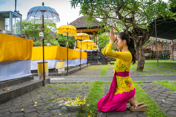 Balinese girl worshipping at a temple
