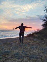Fototapeta premium person on the beach at sunset
