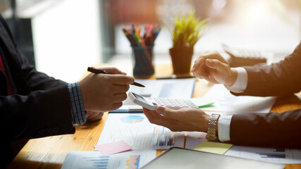 Executive manager managing project budget report with his colleagues