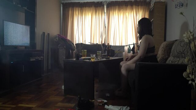 Addicted woman watching TV at living room