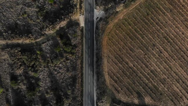 Aerial: road with little traffic in southern France during winter. Zenital shot