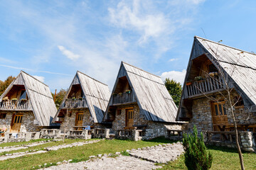 Fototapeta na wymiar Triangular stone houses with wooden roofs. Montenegro, north