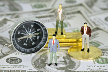 Figures Model,Businessmen, compass, dollars,bitcoin digital currency block chain and gold.Concept investment bitcoin,dollar with gold relationship.