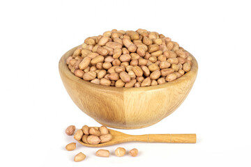 Peanuts on wooden bowl and wooden spoon isolated on white background.