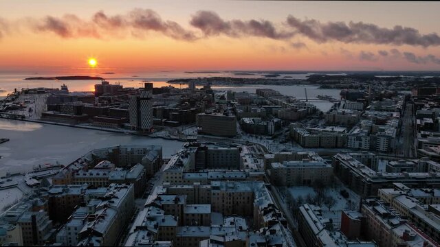 Aerial drone view over Hietalahti towards Jatkasaari, winter sunset in Helsinki, Finland