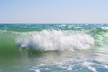 Foaming, rolling, turquoise, sea wave on the beach