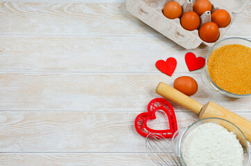 red festive ingrediens for cooking, valentines day eggs in eco package, rolling pin and whisk,...
