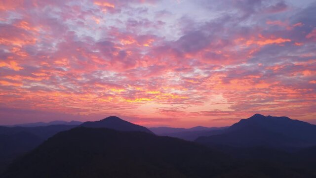 Aerial view Time-lapse of Vanilla dawn sky with Cirrocumulus clouds moving over the silhouette mountains at Mae Hong Son province Unseen journey in Northern Thailand. 