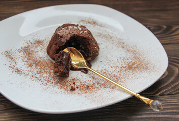  Hot chocolate dessert lava cake with cream and small spoon, close-up