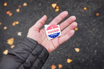 I voted today sticker in a persons hand after voting