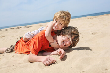 Brothers playing on the beach