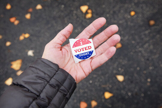 I Voted Today Sticker In A Persons Hand After Voting