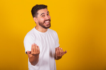 Brazilian Latin American man, with gesture calling, come, come, inviting, receiving, welcoming,...