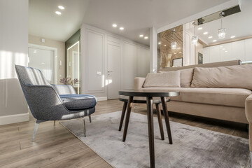 comfortable chairs and table with flowers  in interior the modern living room