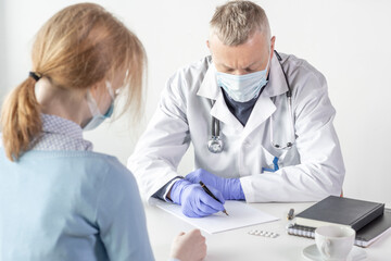a patient at a doctor's appointment in masks