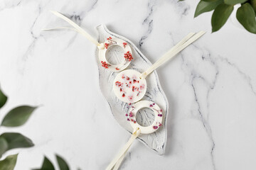 Set of Aroma Sachets with dried flowers with coconut or soy wax. Flatlay on white marble background.