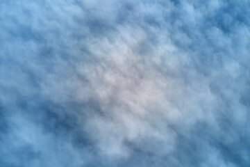 Aerial view from high altitude of earth covered with puffy rainy clouds forming before rainstorm