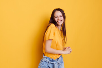 attractive woman in a yellow t-shirt emotions summer style yellow background