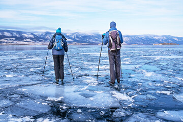 Tourists skate on the ice of Lake Baikal. Nordic Skate skates designed specifically for skating on lakes, rivers, canals and bays. active rest. Winter vacation and travel concept.