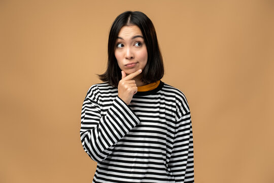 Thoughtful upset girl pondering serious issues, looking with uncertain hesitant expression