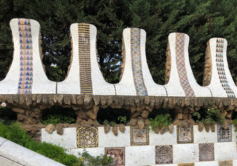 Detail of mosaic wall at the entrance to Park Guell in Barcelona, showcasing the mastery of architect Antoni Gaudi with mosaics.