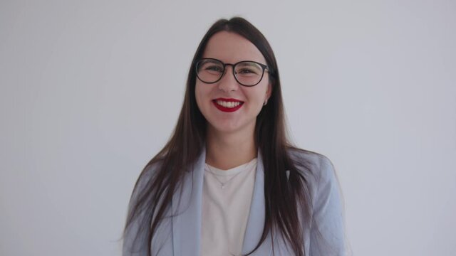 Successful young business lady in glasses laughs and makes a hand gesture. Leadership and success concept. Feminism. Women power