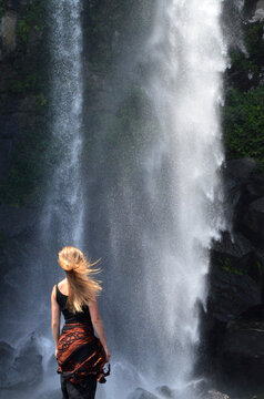 Hippie girl and wild waterfall