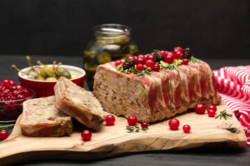 Traditional French terrine covered with bacon on dark wooden background