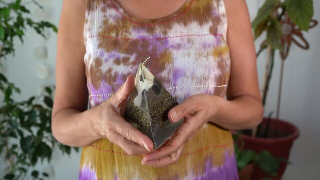 Close-up of woman examining orgonite pyramid