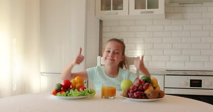little girl wants to eat vegetables and fruits. the child enjoys fresh fruits and vegetables. girl showing thumbs up. copy space